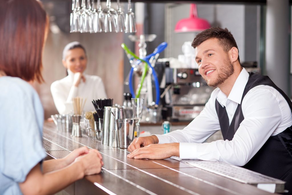 bartender speaking to a female customer